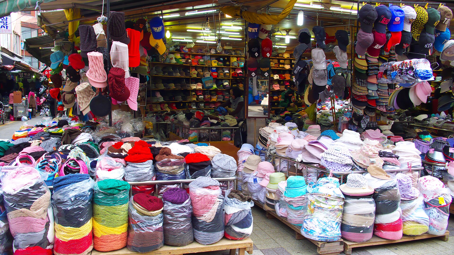 Photo of a storefront filled with hats of many styles and colors