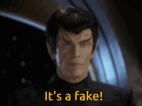 Picture of a Romulan senator holding up a data rod with the caption 'It is a fake'